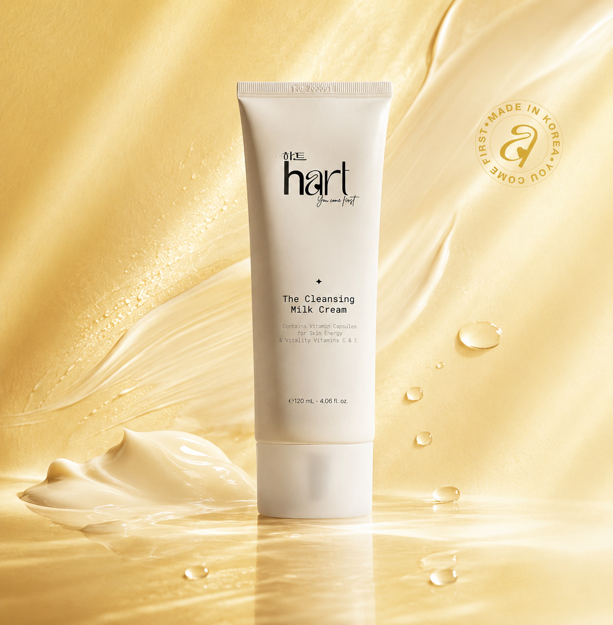A white tube of Blue Hart Cleansing Milk Cream stands centered against a flowing golden cream background with glossy droplets and a swan logo seal reading Made in Korea.